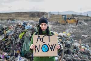 girl with act now sign at refuse site