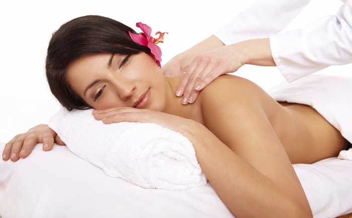 woman with flower in hair having massage