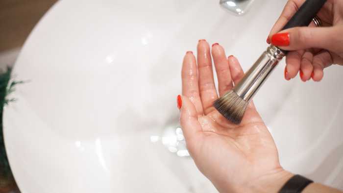 brush on hands over sink brush on hands over sink