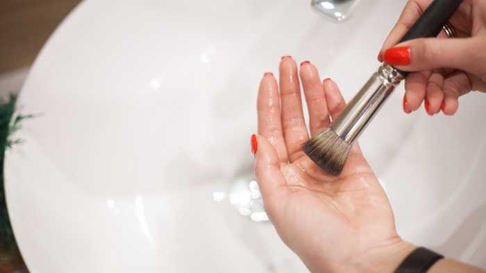 brush on hands over sink