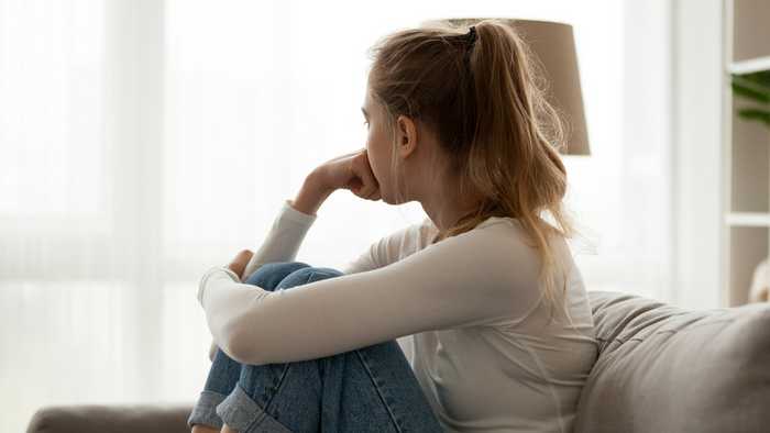 Anxious woman starring out of a window