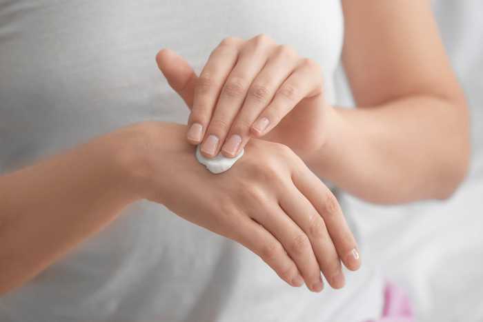 hand being moisturized hand being moisturized