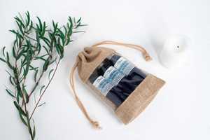 Oleo natural beauty products in a bag with rosemary Oleo natural beauty products in a bag with rosemary