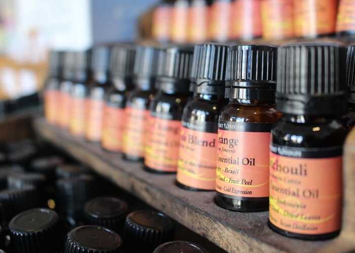 Citrus essential oils neatly stacked on a shelf in the Oleo Bodycare workshop