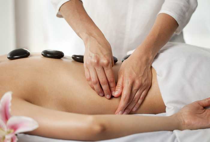 woman having a stone massage woman having a stone massage