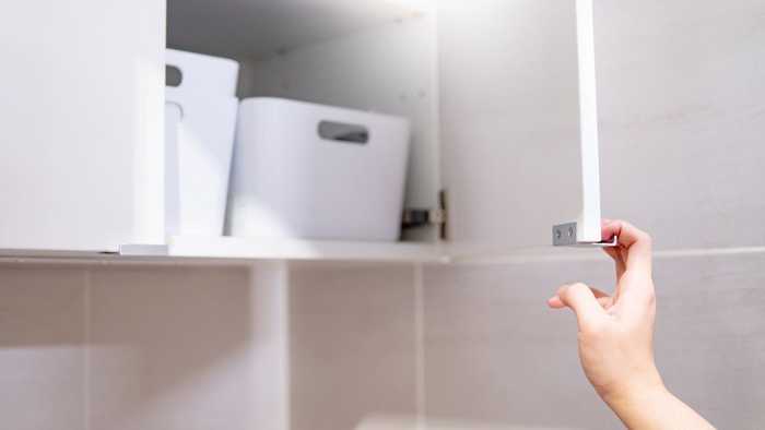 opening a cupboard in the bathroom