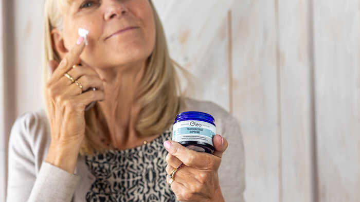 lady applying moisturiser to her face with a combination skin type