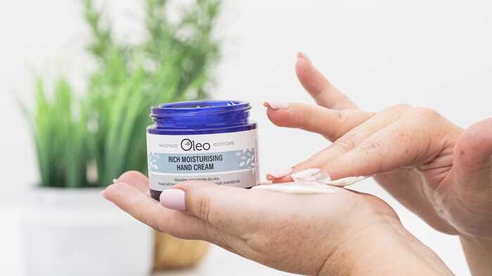 lady applying Oleo Rich Moisturising Hand Cream to her hands lady applying Oleo Rich Moisturising Hand Cream to her hands