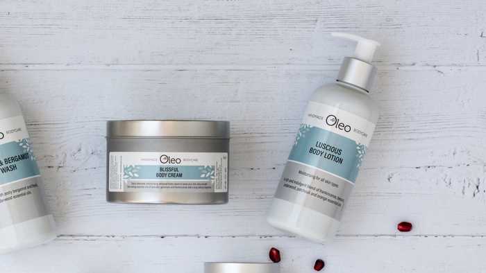 Oleo Bodycare Blissful Body Cream and Luscious Body Lotion on a wooden table top