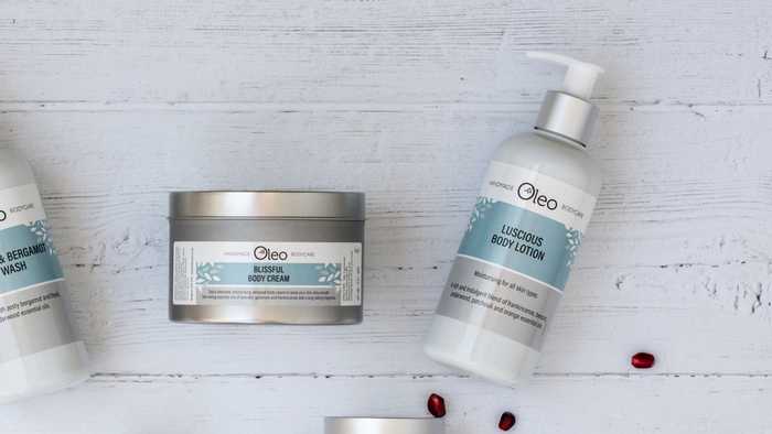 Oleo Bodycare Blissful Body Cream and Luscious Body Lotion on a wooden table top Oleo Bodycare Blissful Body Cream and Luscious Body Lotion on a wooden table top