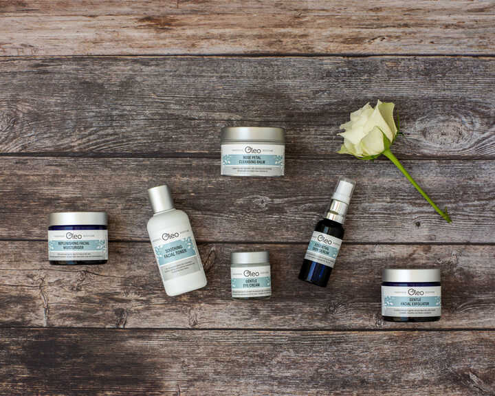 Oleo Bodycare range of award-winning vegan skincare laid on a wooden table