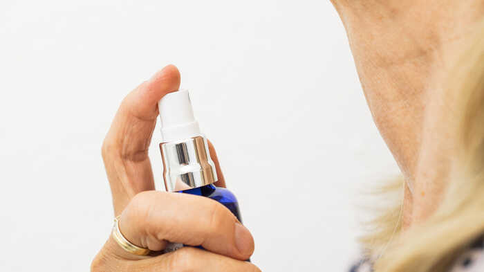 Olivia spraying Oleo Bodycare Eau de Toilette onto her neck Olivia spraying Oleo Bodycare Eau de Toilette onto her neck