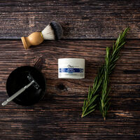 Aromatic Shaving Cream on a table with a razor and shaving brush