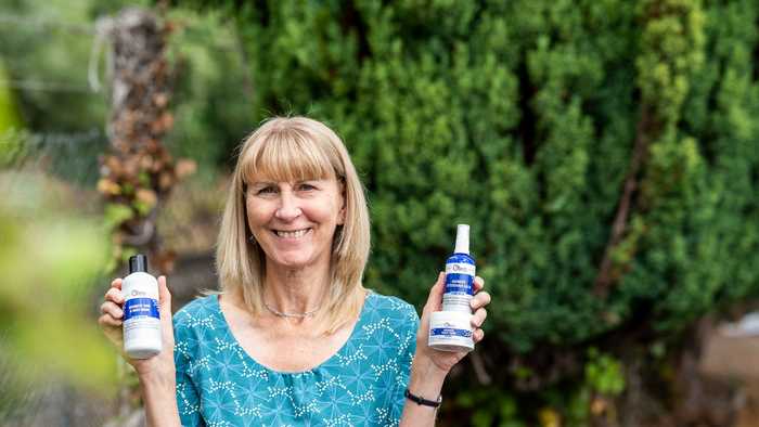 Olivia, Oleo Bodycare Founder, holding her vegan skincare products