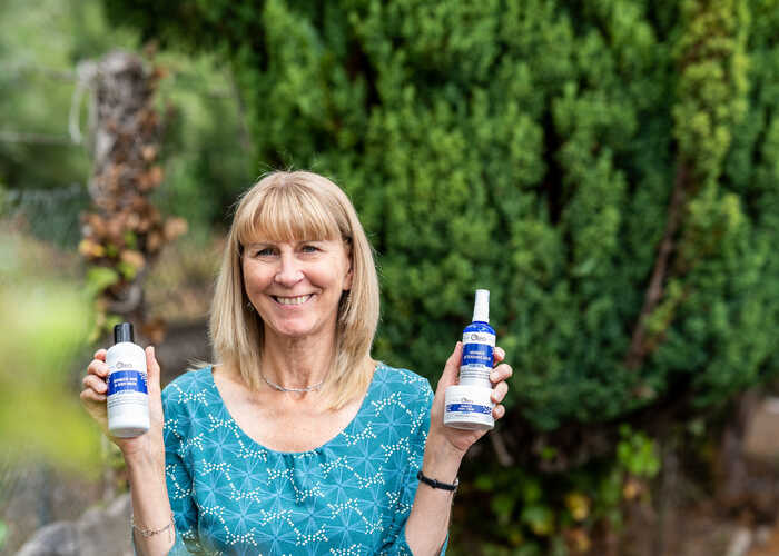 Oleo Bodycare founder, Olivia, holding palm oil-free products