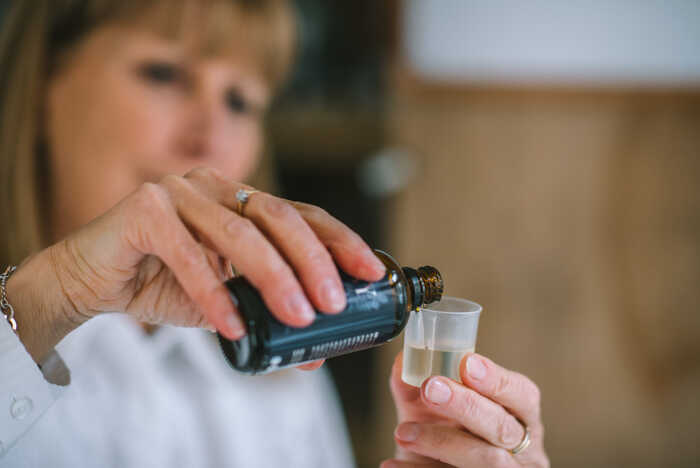 Olivia Chapman handmaking essential oil infused skincare products