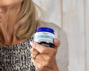 woman applying Oleo SPF30 Face Cream