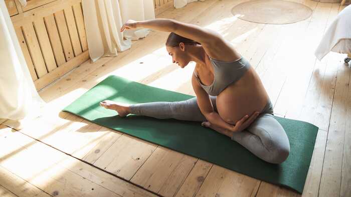 pregnant lady doing yoga to help manage stress during pregnancy
