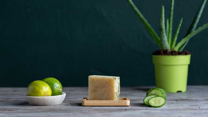 Handmade Cucumber, Aloe & Lime Soap Hand blended vegan soap displayed on a table with raw ingredients