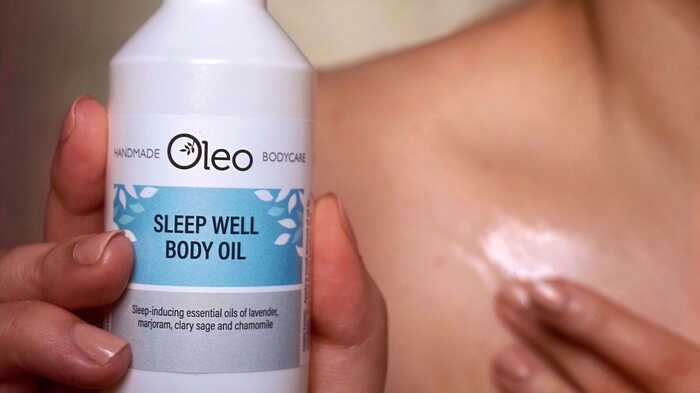 Woman applying Sleep Well Body Oil