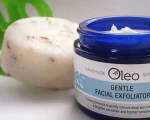 Oleo Gentle Facial Exfoliator jar next to a round exfoliating soap.