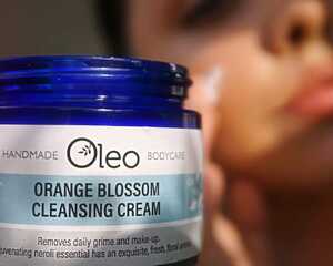 Woman applying Orange Blossom Cleansing Cream