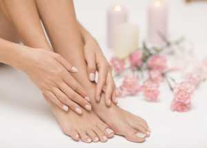 A woman's moisturised hands and feet 